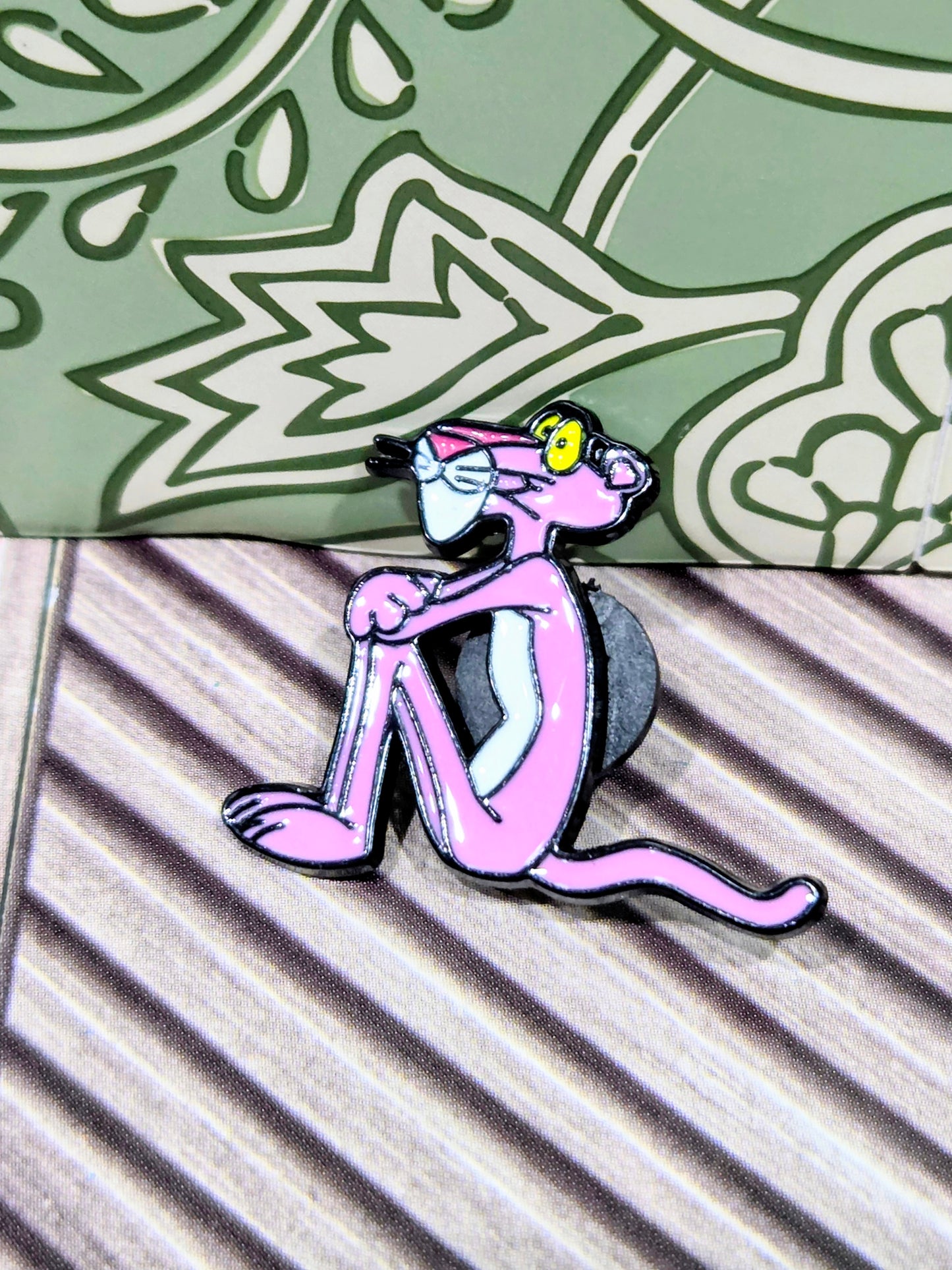 Enamel cat character pin in pink and black, side pose with tail