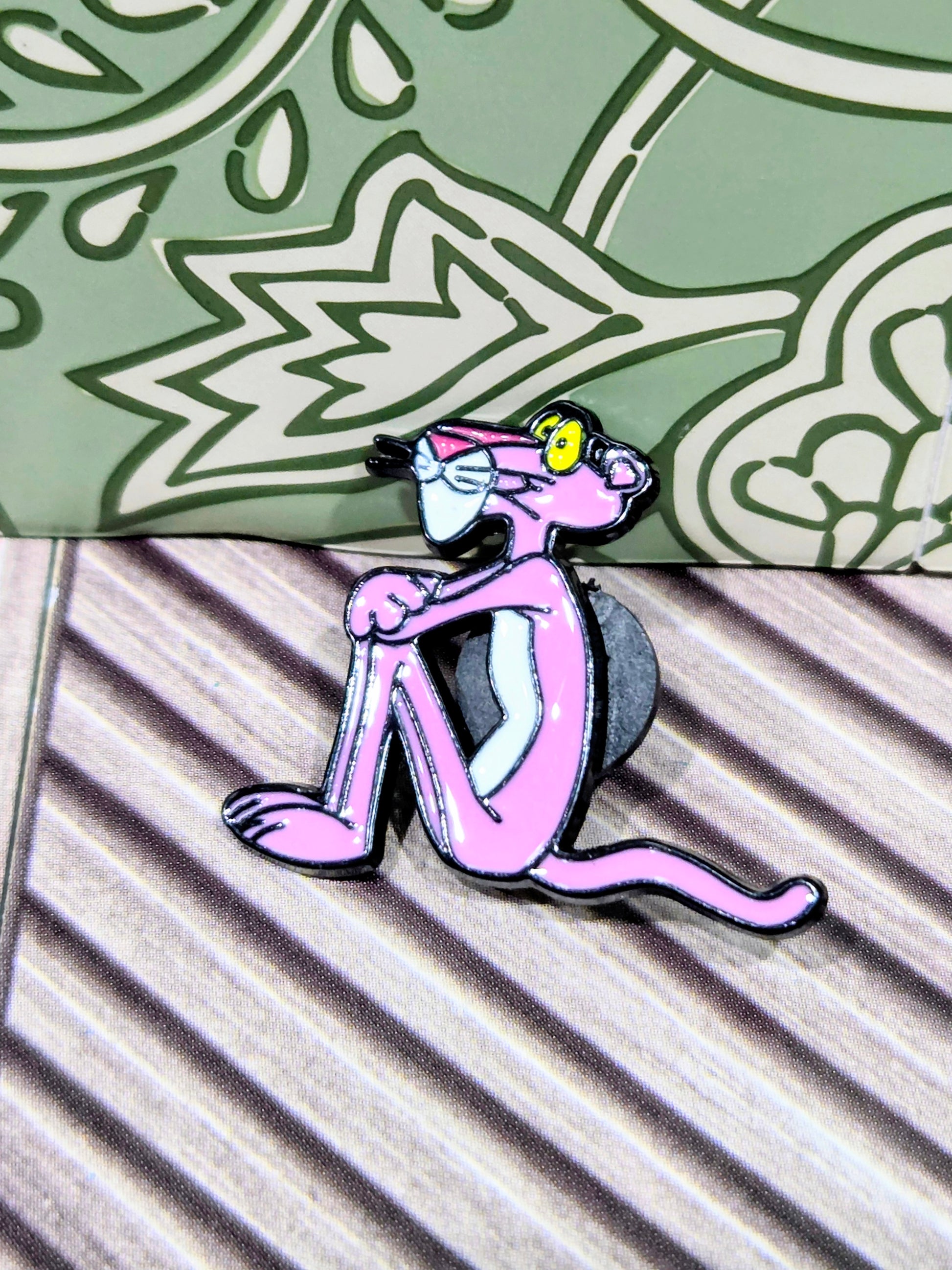 Enamel cat character pin in pink and black, side pose with tail