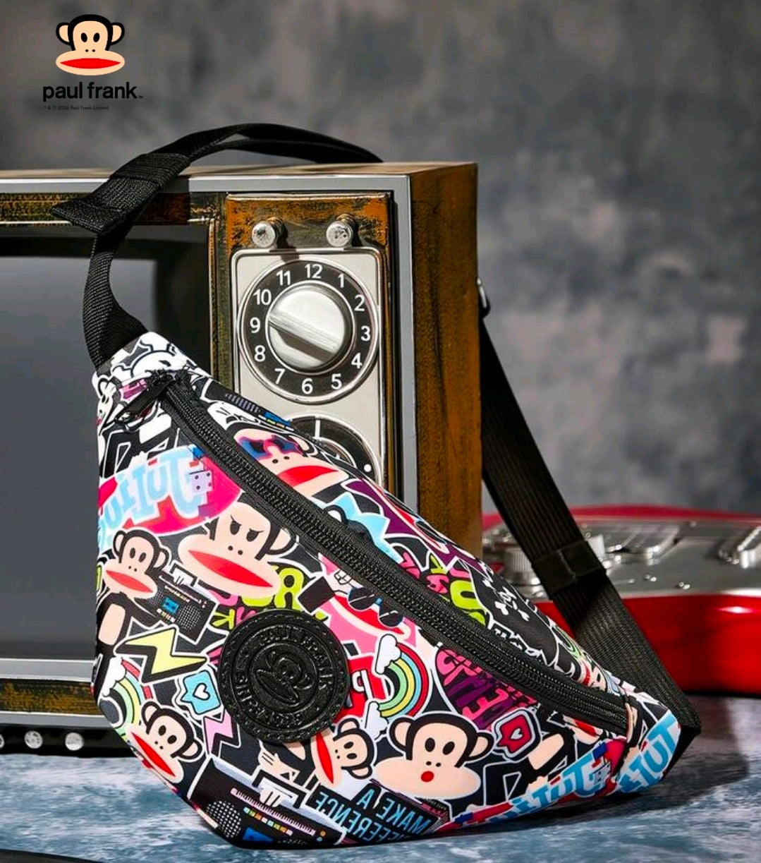 Front 3/4 view of colorful monkey sticker belt bag with black logo patch