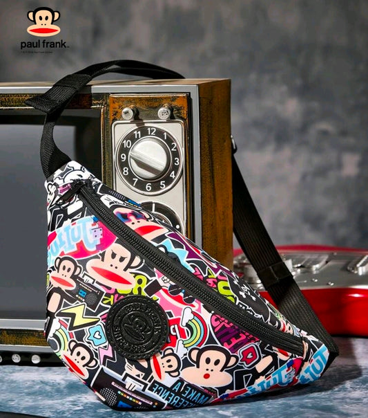 Front 3/4 view of colorful monkey sticker belt bag with black logo patch