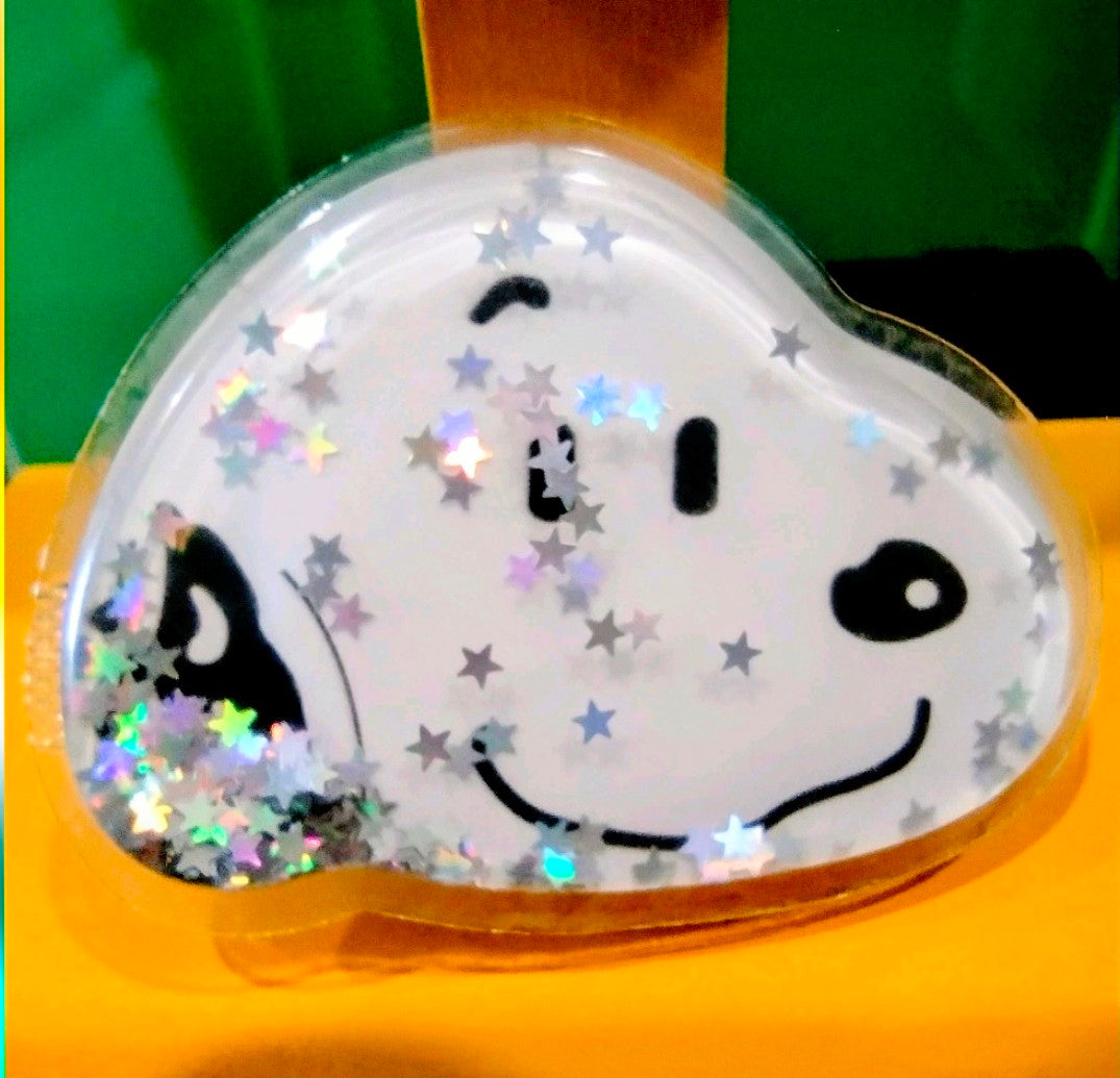 Heart-shaped glitter phone grip with Snoopy face and star accents