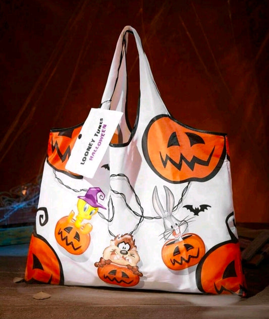 White Looney Tunes Halloween tote bag with orange jack-o-lantern print and black handles