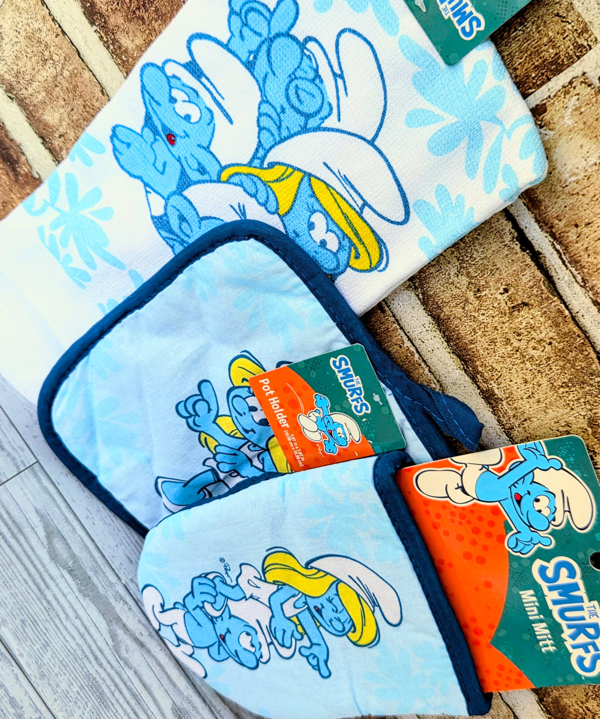 Smurfs patterned bento towel and tote-style fabric pouch with orange label