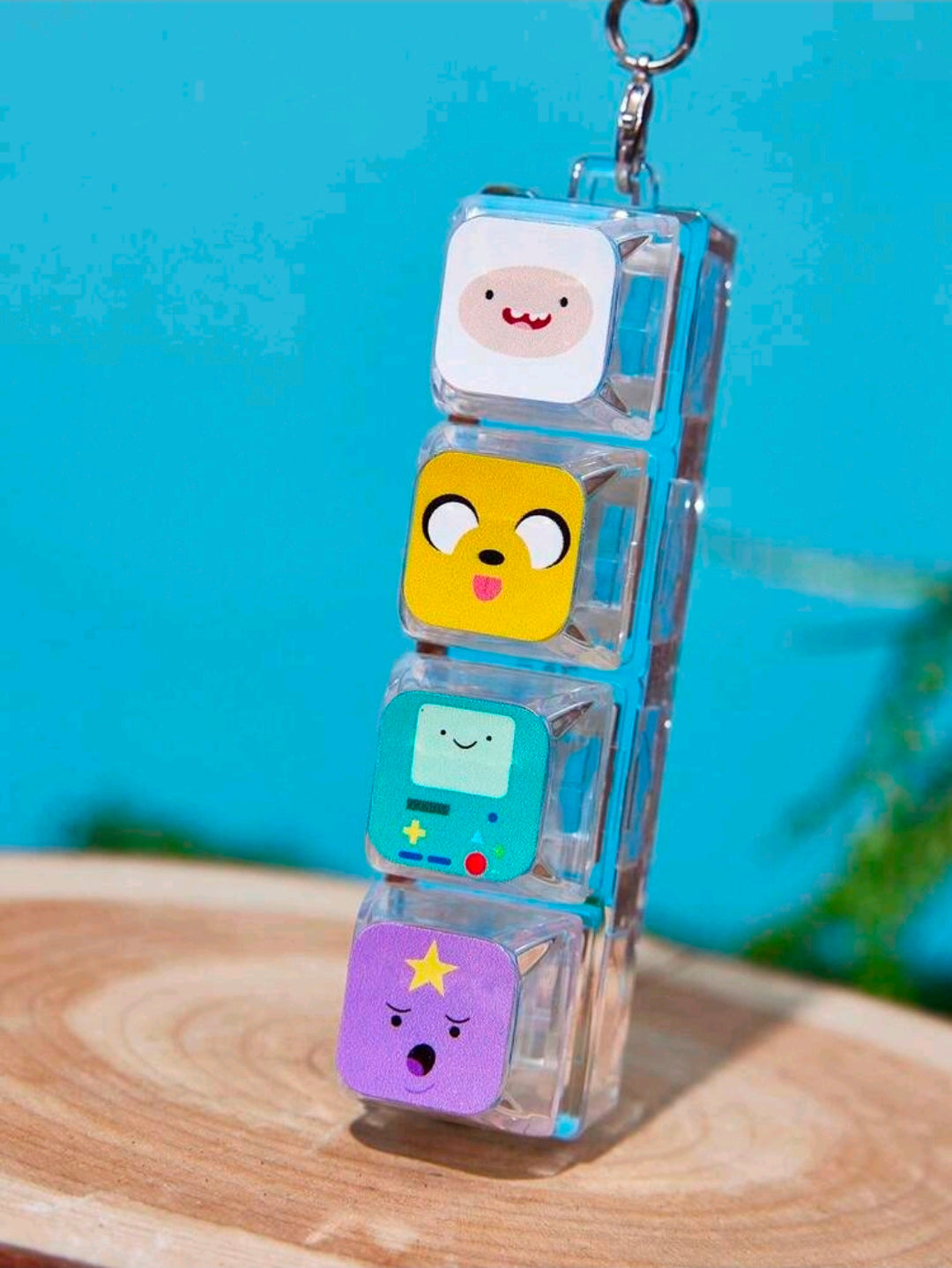 Clear acrylic charm stack with four character faces and silver key ring