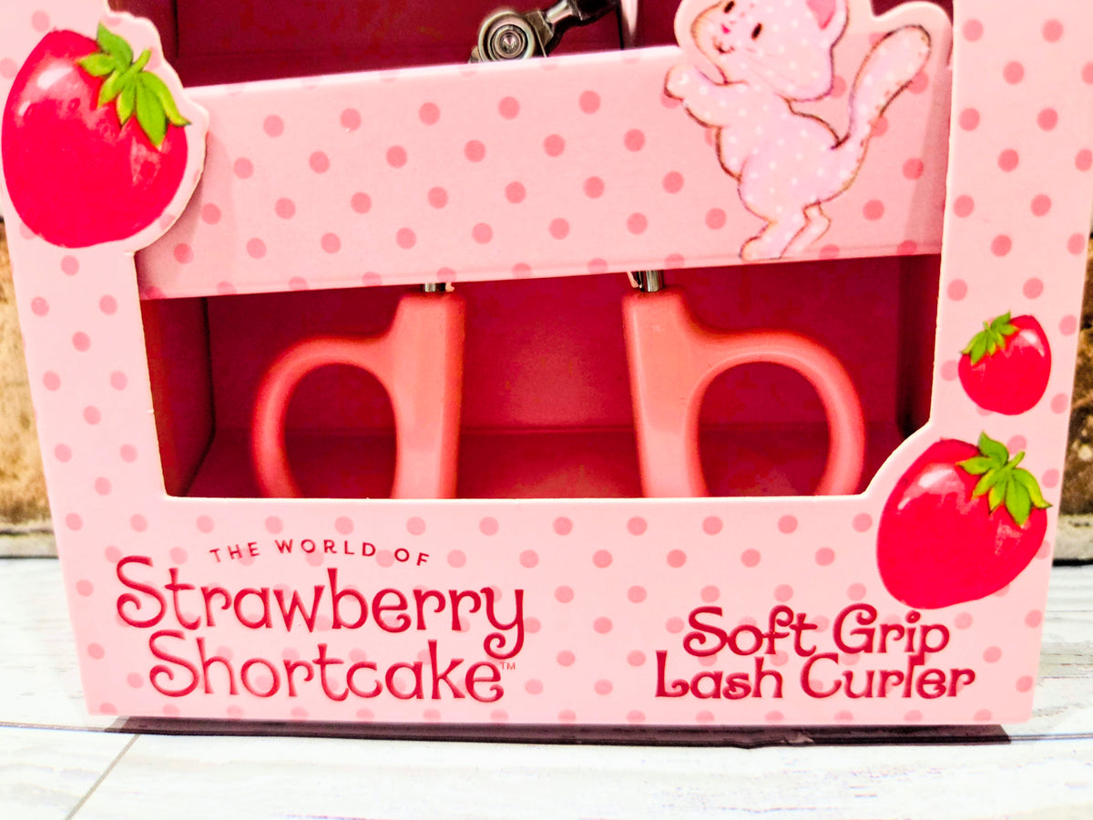 Pink strawberry eyelash curler retail box front with Soft Grip Lash Curler text