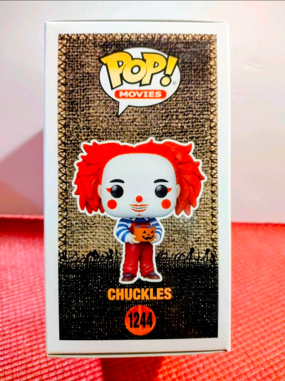 Chuckles Funko Pop! figure in boxed packaging, red wig and smiling clown face