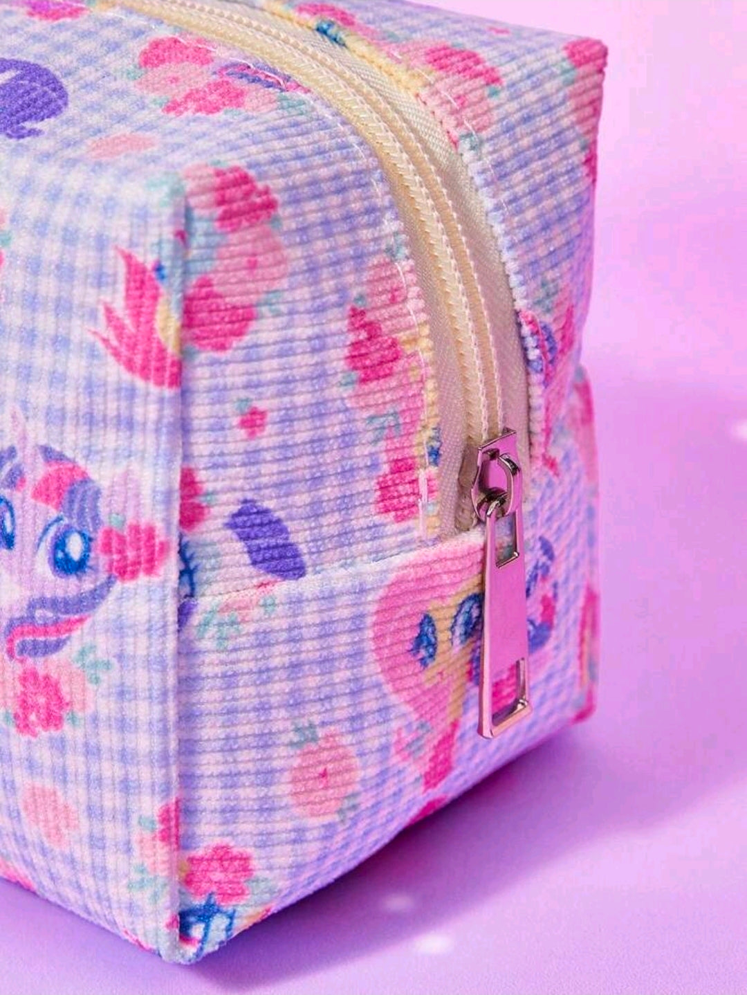 Boxy zip pouch in light-blue gingham with pony prints and tan gold zipper