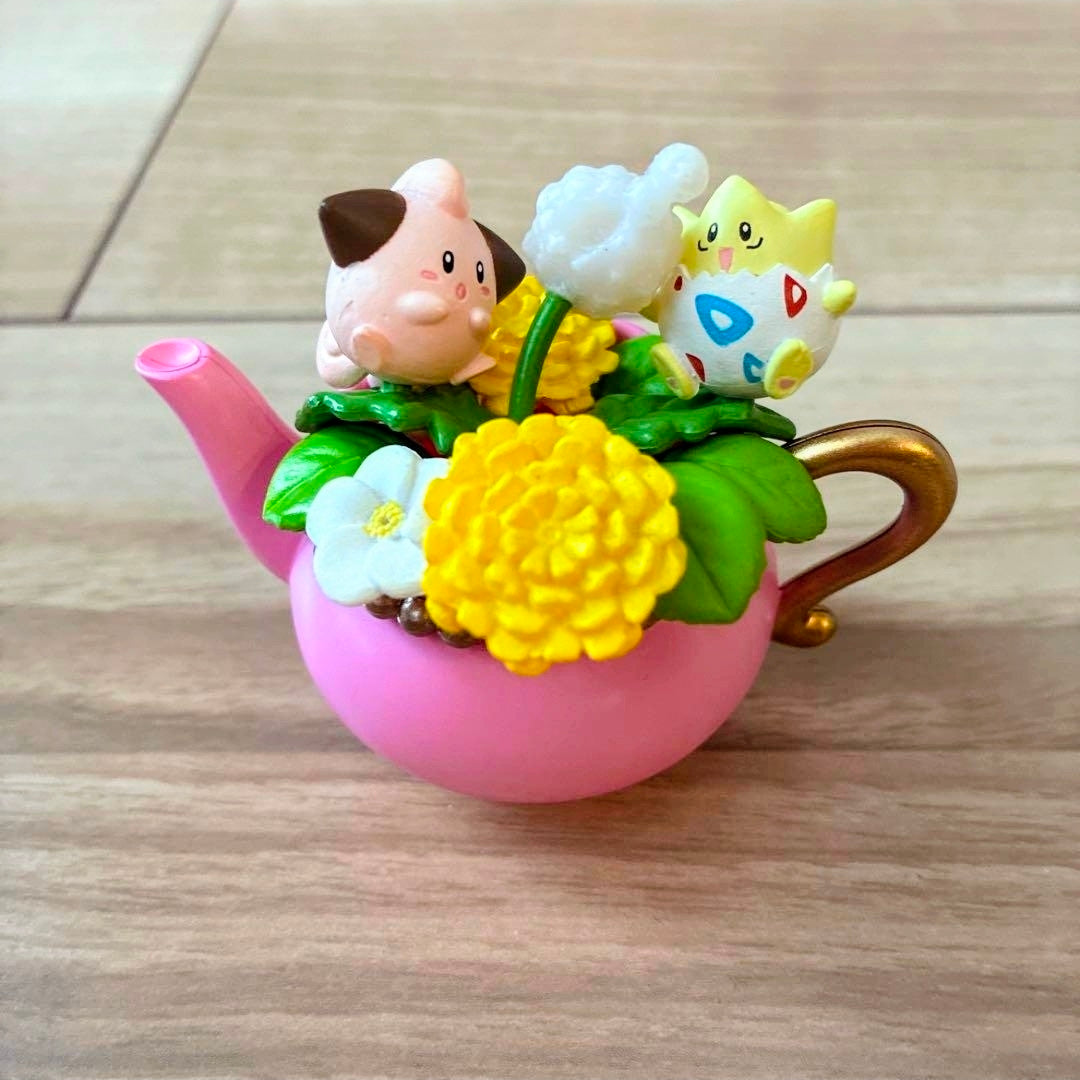 Pink teacup mini figure with pig and yellow flower center plus white blossoms