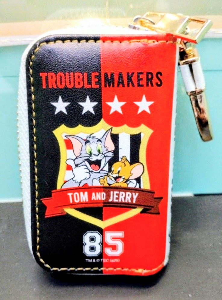 Red-and-black smart key case front with “Trouble Makers” stars and 85 emblem