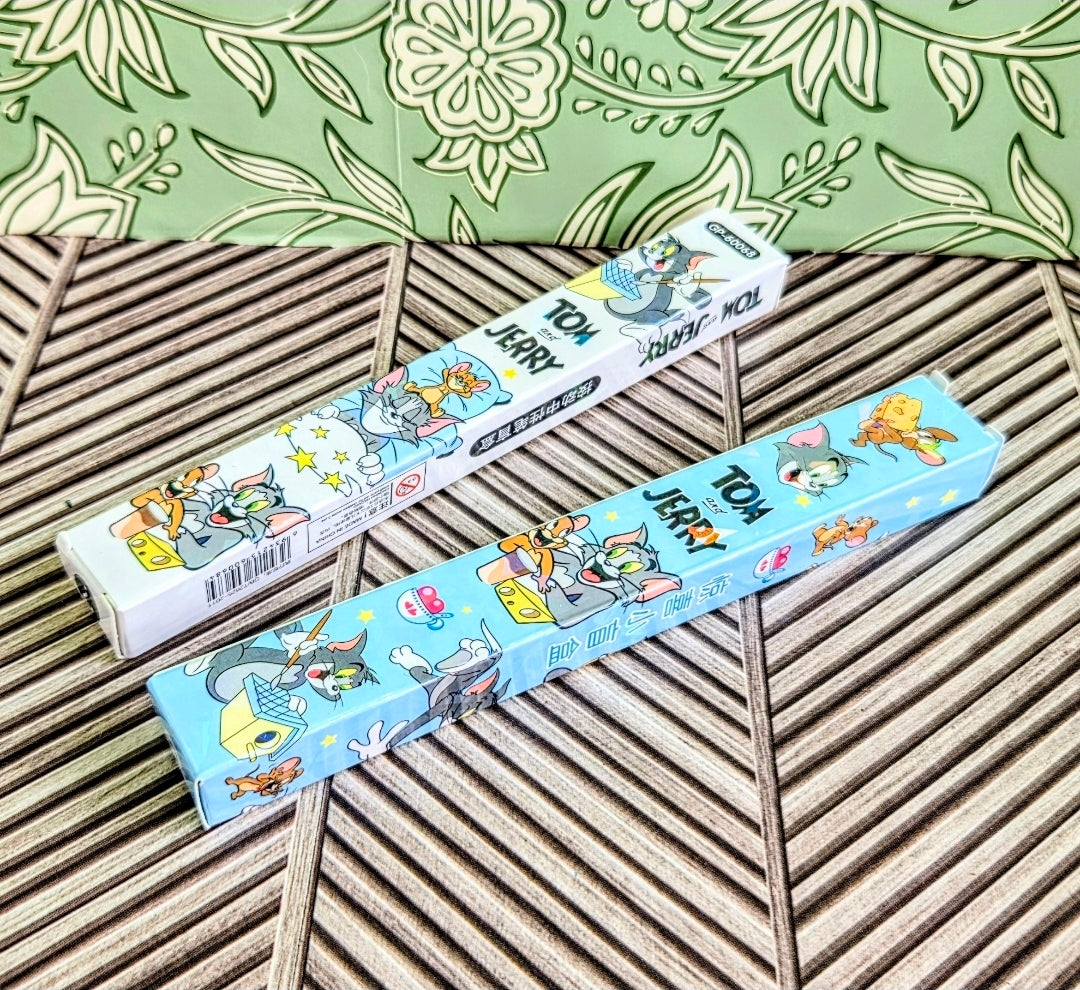 Tom & Jerry gel pen boxes in blue and white packaging on bamboo-style tray
