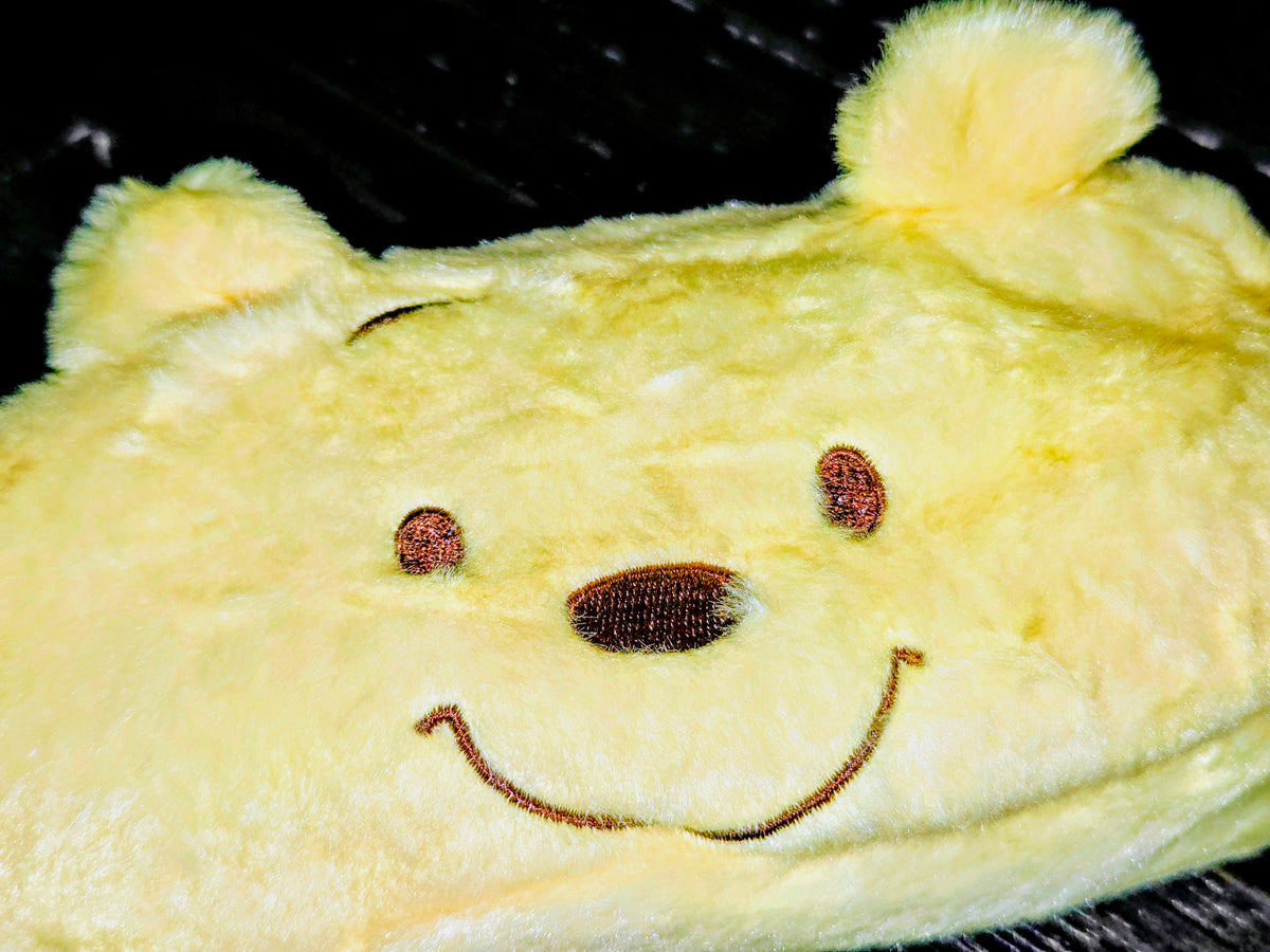 Winnie the Pooh plush zipper pouch close-up with smiling embroidered face