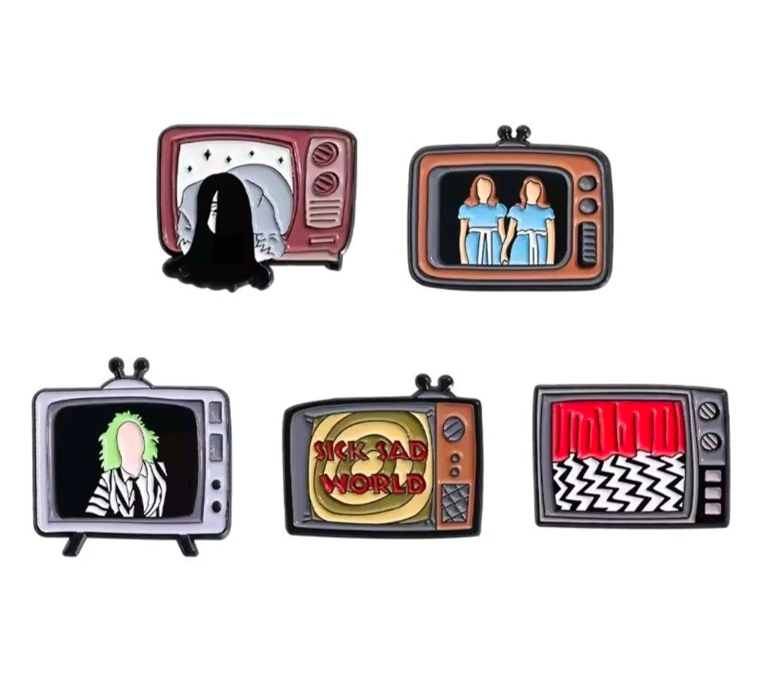 Five-piece enamel pin set with five TV character displays, pins arranged flat.