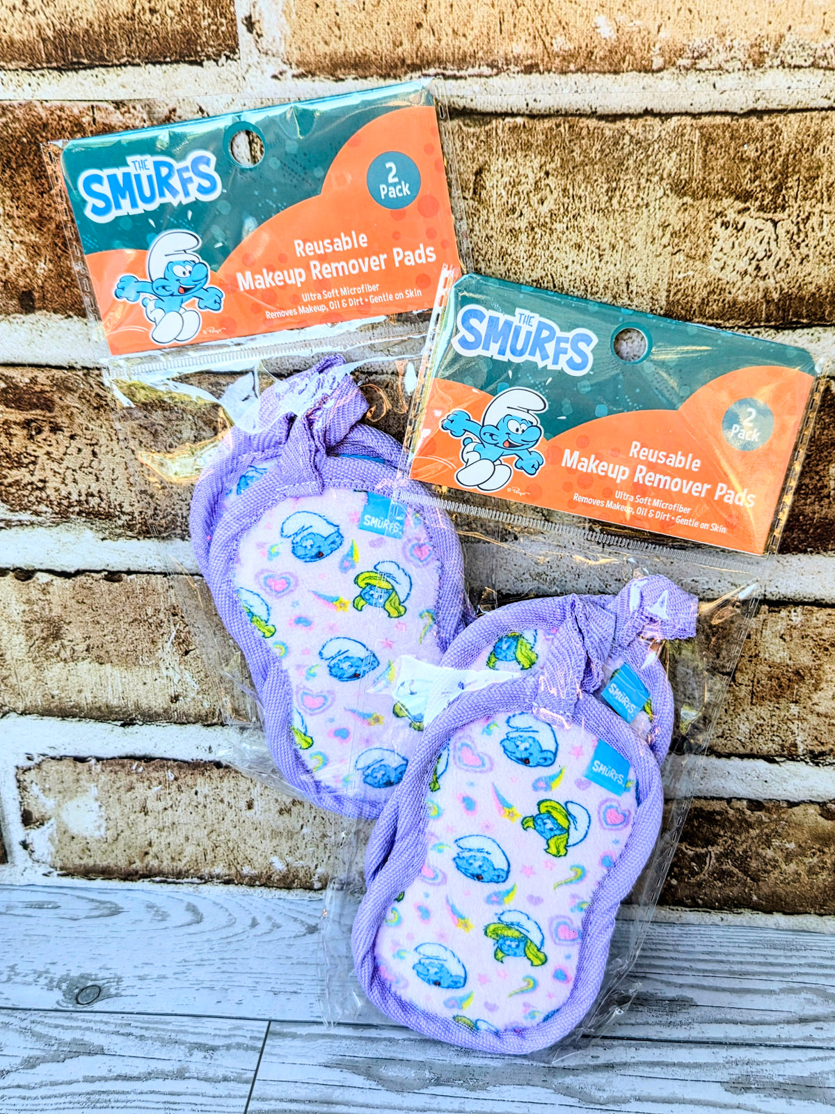 Purple set of reusable makeup remover pads with printed cartoon faces