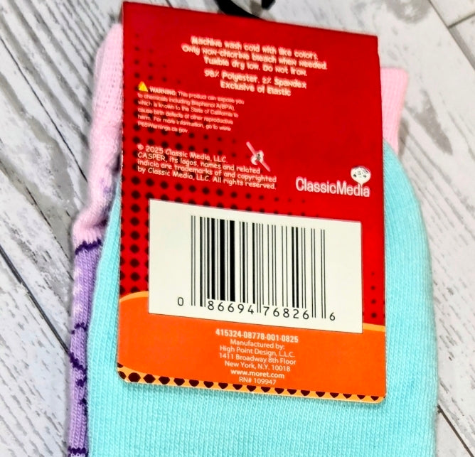 Crew socks in light blue with purple seam, showing care label tag
