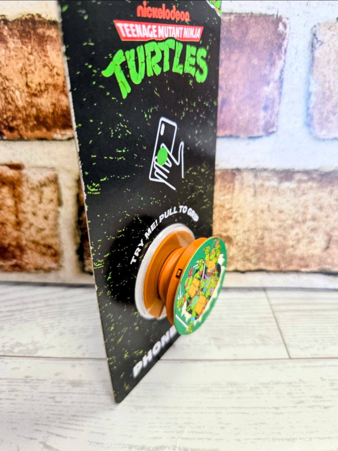 Teenage Mutant Ninja Turtles phone grip holder with pop-out ring and logo