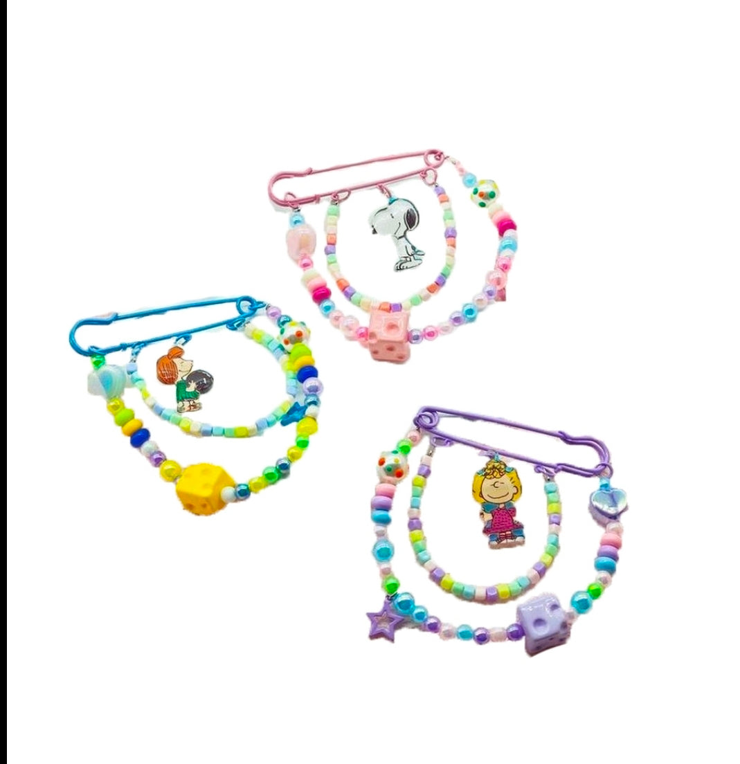 Set of four Peanuts beaded safety pin keychains with colorful beads and dangling charms