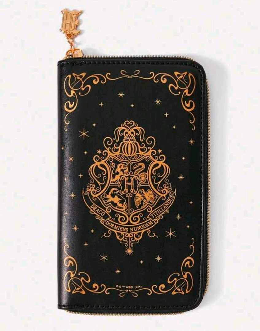 Black zippered makeup brush case with gold Hogwarts crest and decorative details, with key charm