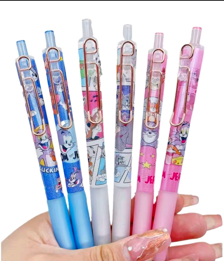 Hand holding Tom & Jerry gel pens in blue and pink with clear clips