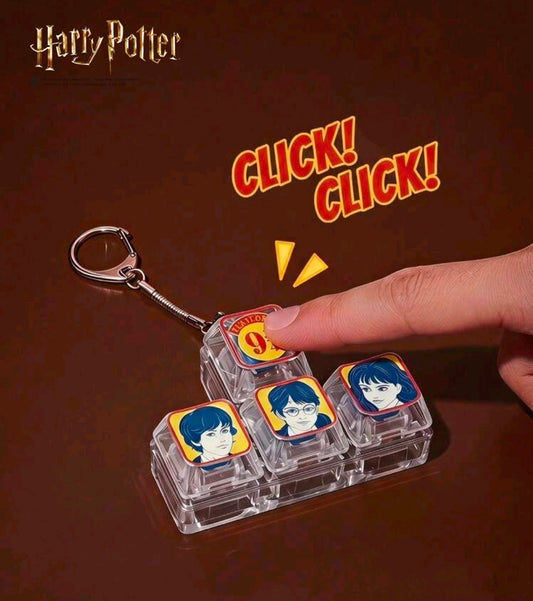 Platform 9 3/4 clicker keychain with clear character tiles and orange CLICK! graphic
