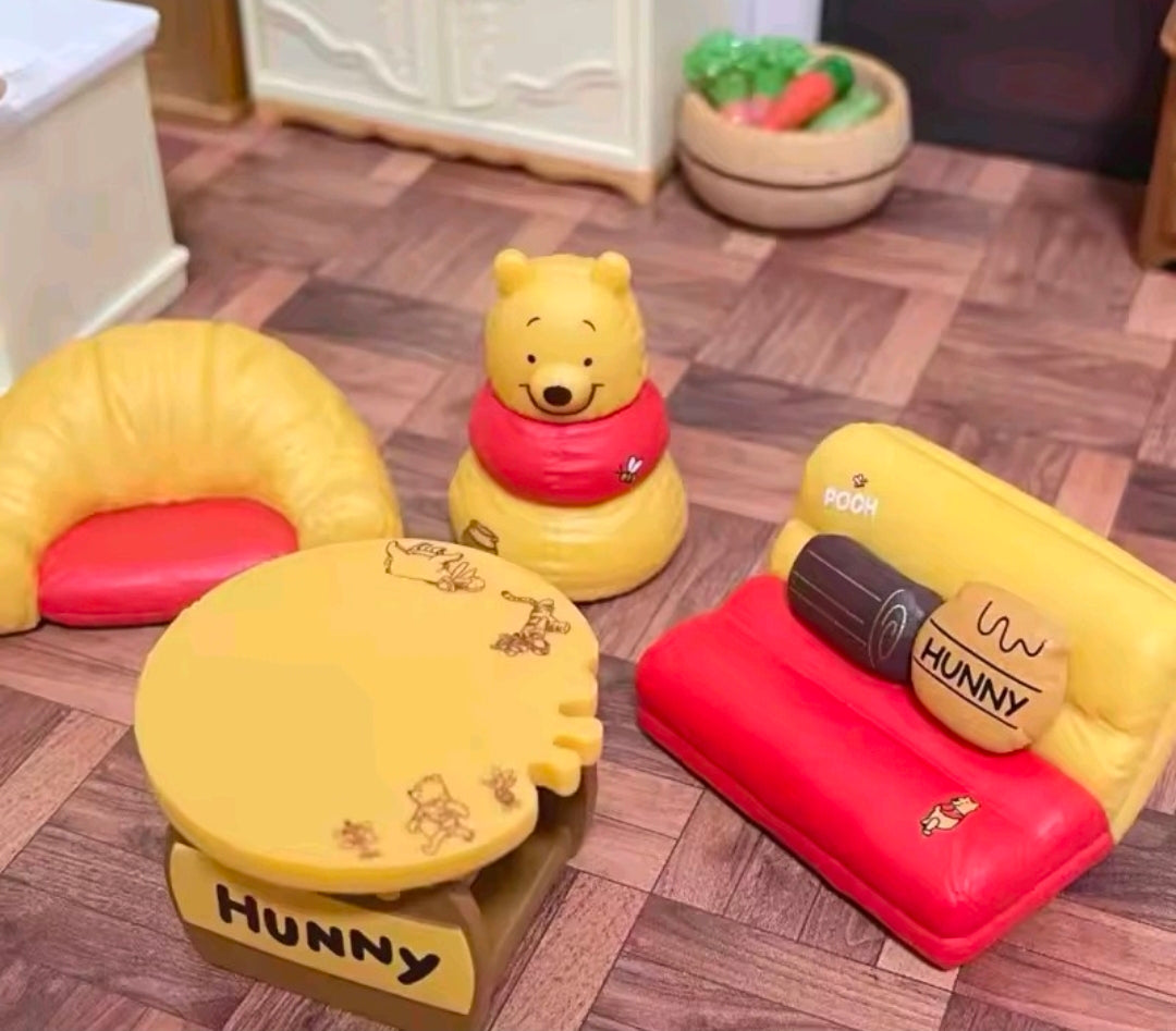 Plush Hunny table, red sofa, yellow beanbag, and Pooh figure with toy accessories