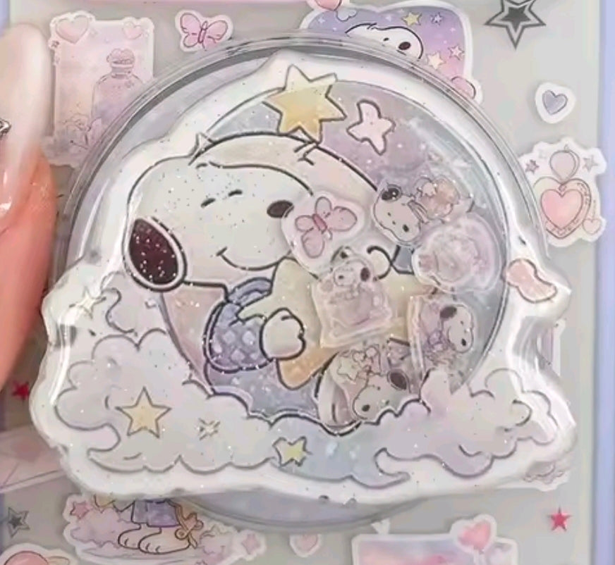 Close-up Snoopy acrylic glitter shaker grip with stars and clouds inside clear bubble