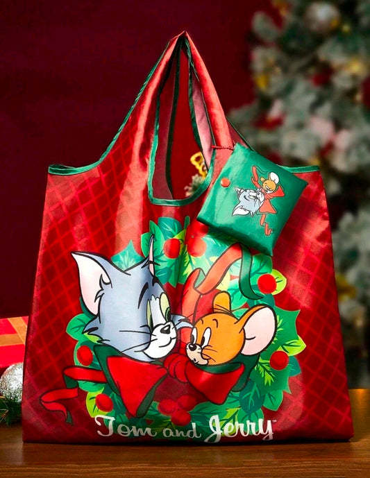 Holiday reusable tote bag with Tom and Jerry print and green snap storage pouch.