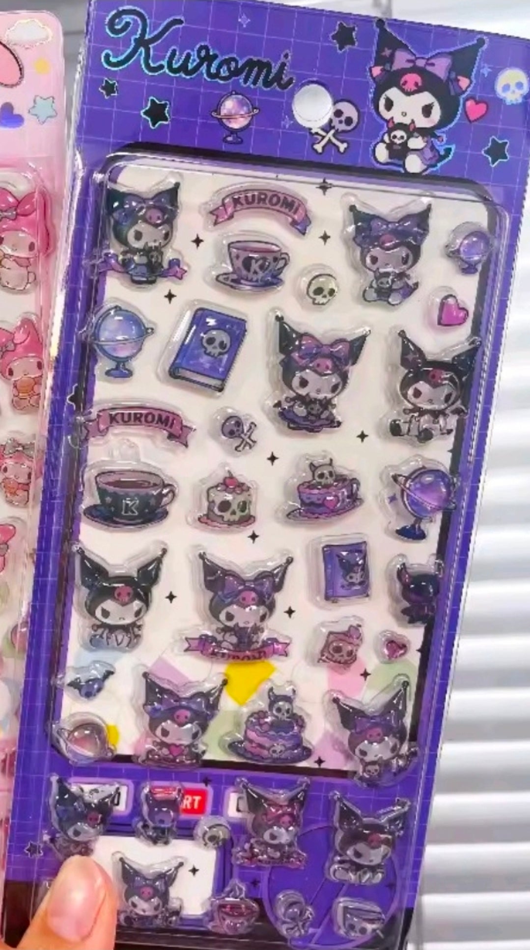 Kuromi puffy sticker sheet in purple with cat-themed faces and symbols