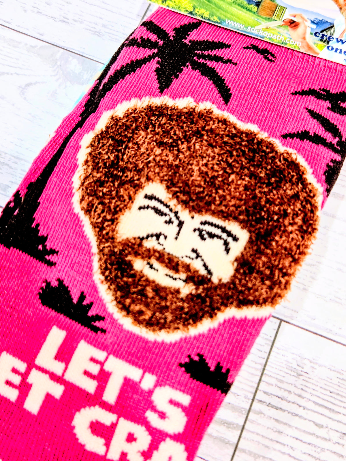 Pink crew sock with brown beard face graphic close-up and bold black accents