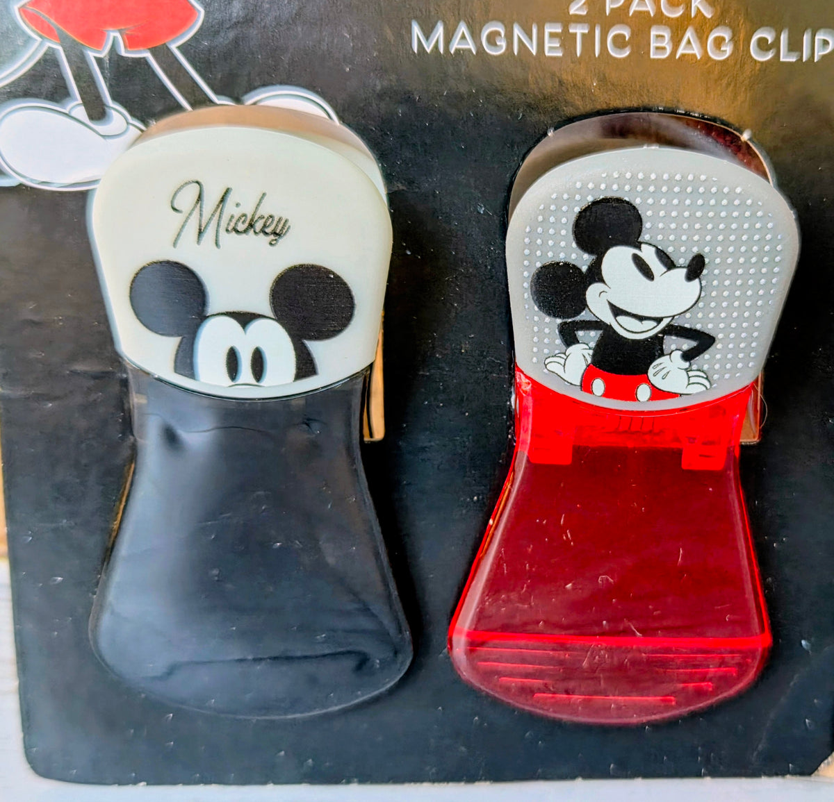 Two magnetic bag clips with Mickey and Minnie faces on red and gray bodies