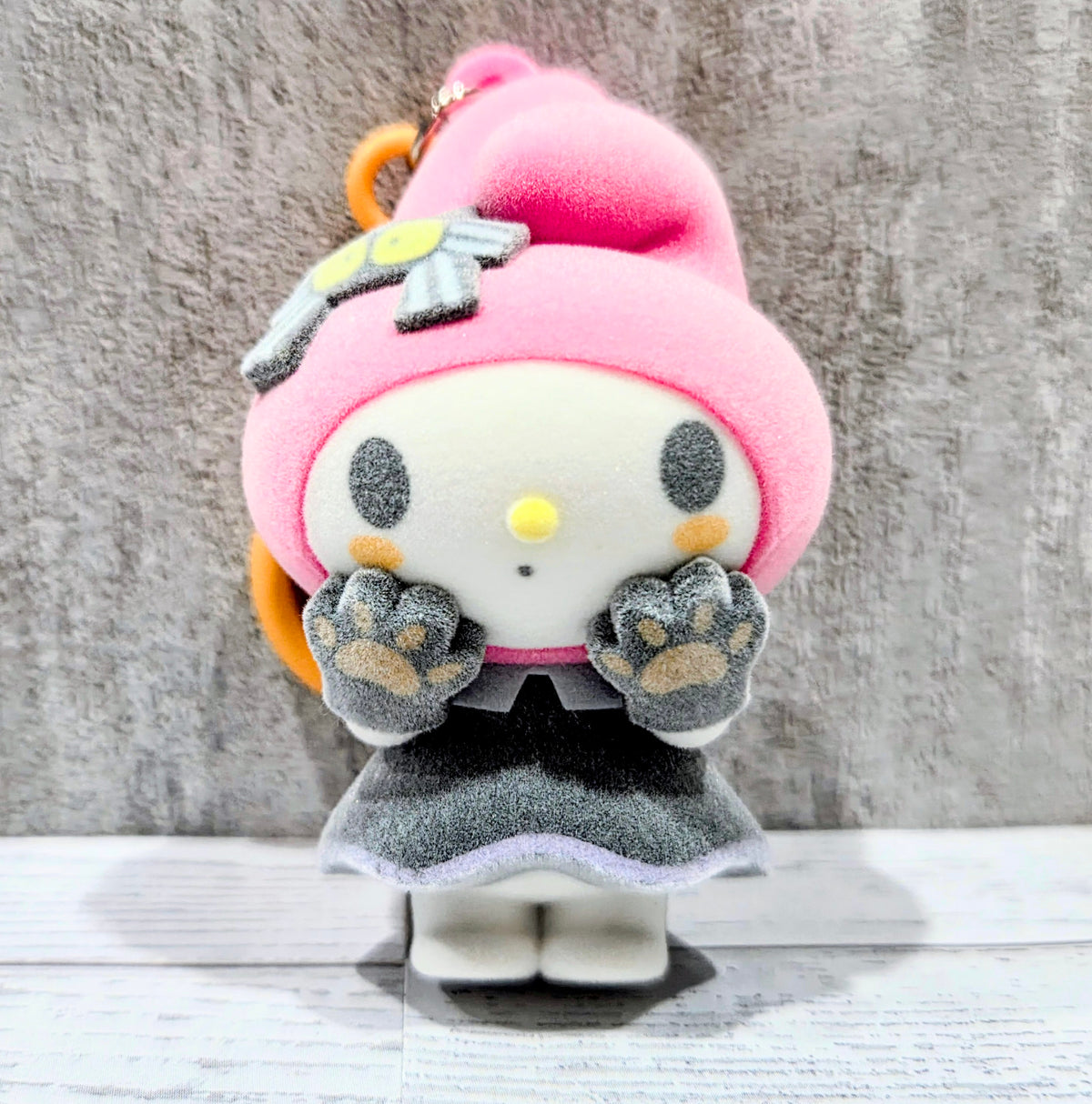 Front view My Melody witch-hat flocked bag clip with orange loop and grey hands