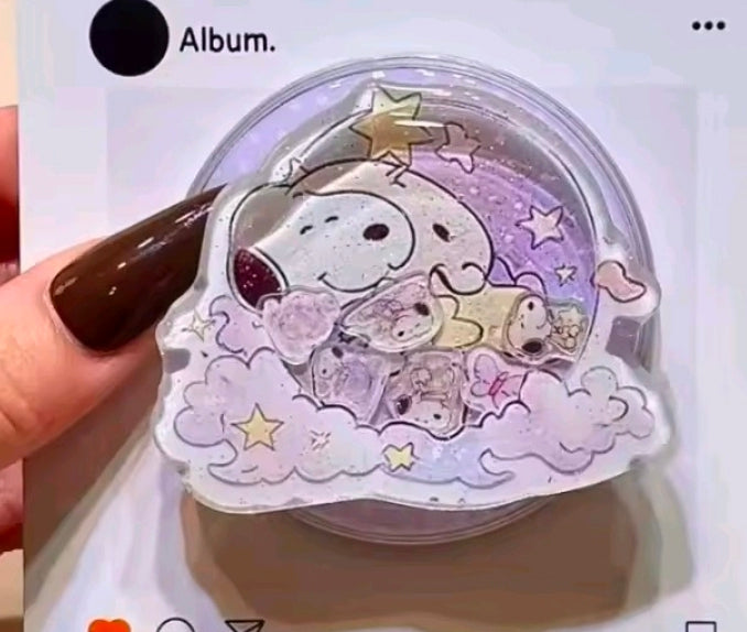 Round acrylic glitter shaker phone grip featuring Snoopy in purple clouds with sparkles