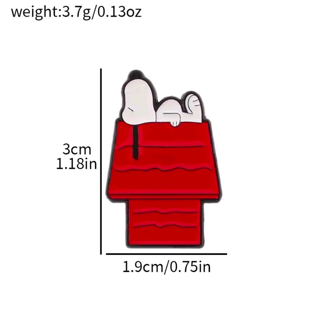 Red bag-shaped enamel pin with small Snoopy dog head and black outlines