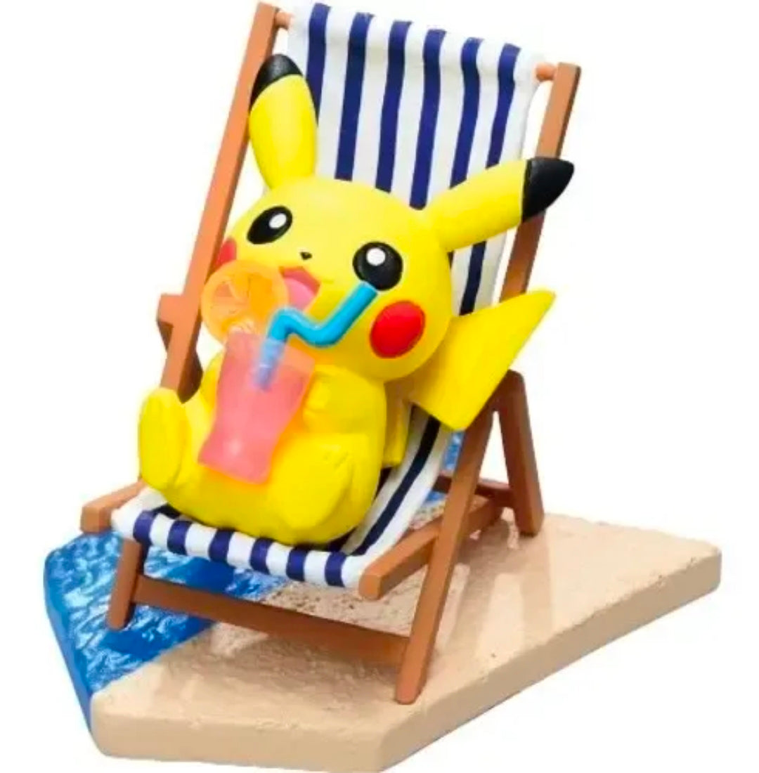Pikachu seaside mini figure on a striped beach chair holding a drink