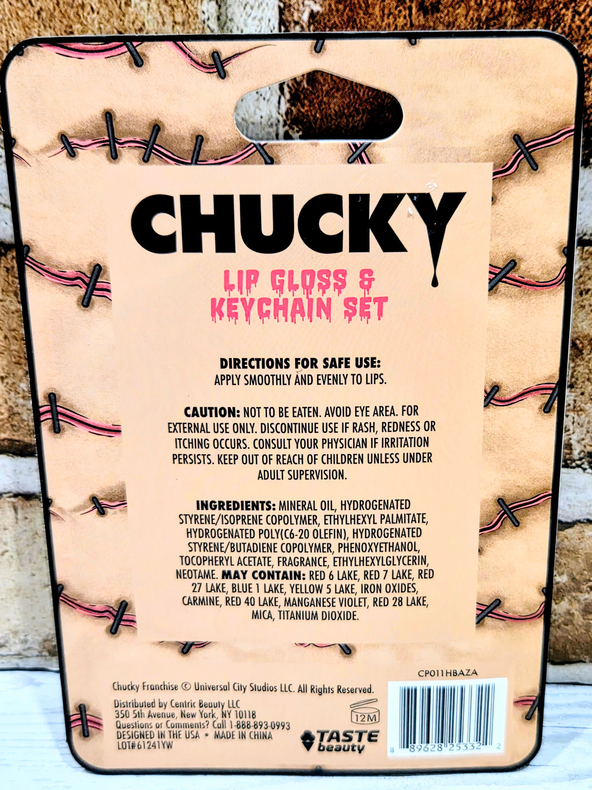 Chucky lip gloss and keychain set blister package with warning and ingredient text