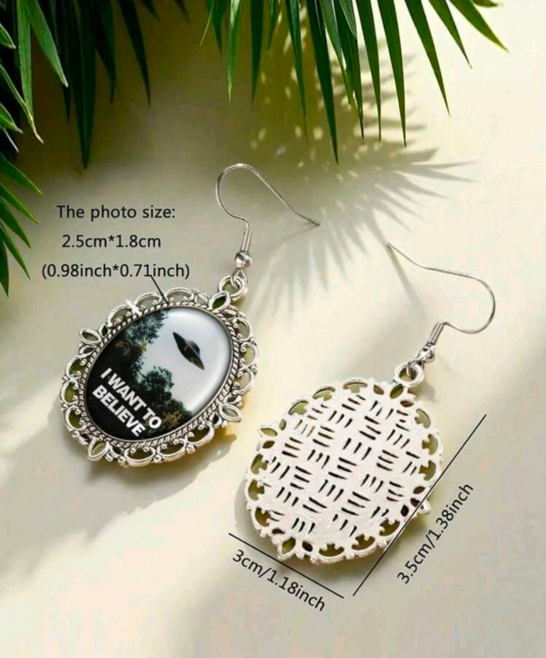 Silver oval dangle earrings with UFO art and I Want to Believe wording