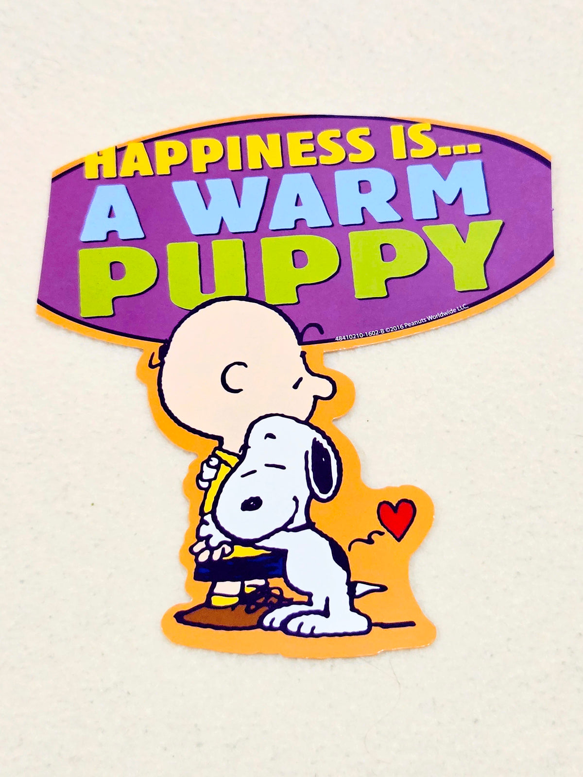 Purple Peanuts wall decor cutout with Charlie Brown and Snoopy: "Happiness is... a warm puppy"