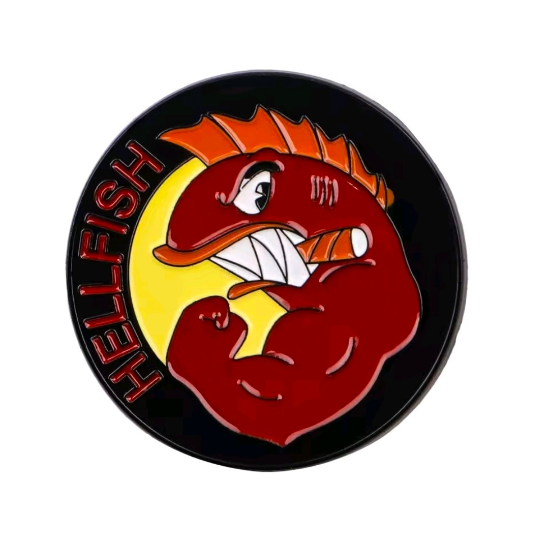 Round Hellfish enamel pin with red fish head and yellow accents