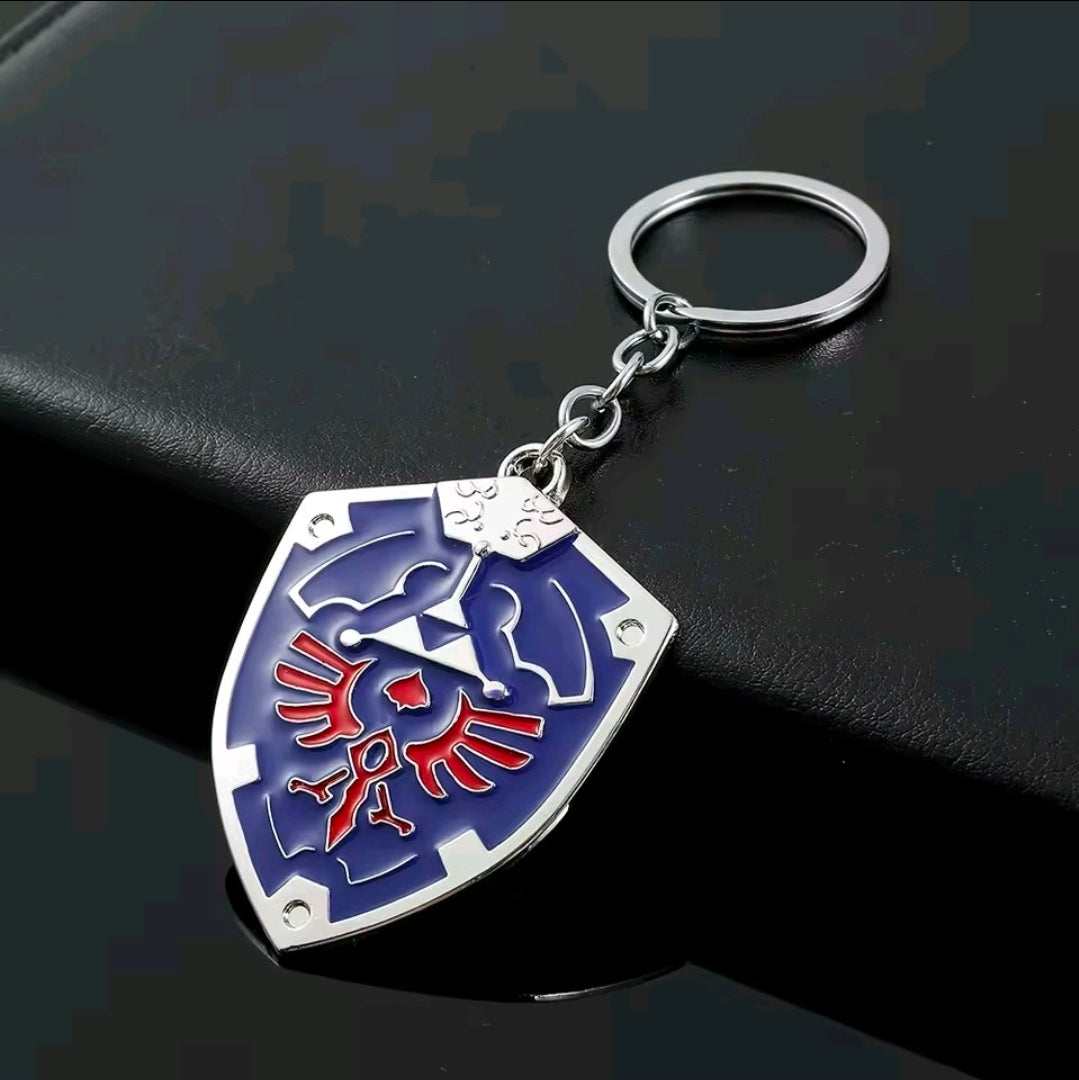 Blue shield enamel keychain with silver split ring and chain, red Triforce emblem detail