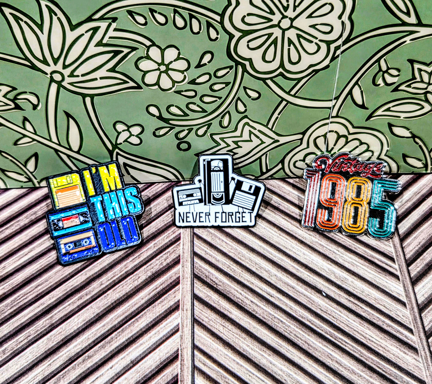 Enamel pin set with three pins: 'I'm This Old', 'Never Forget', and 'Vintage 1985'