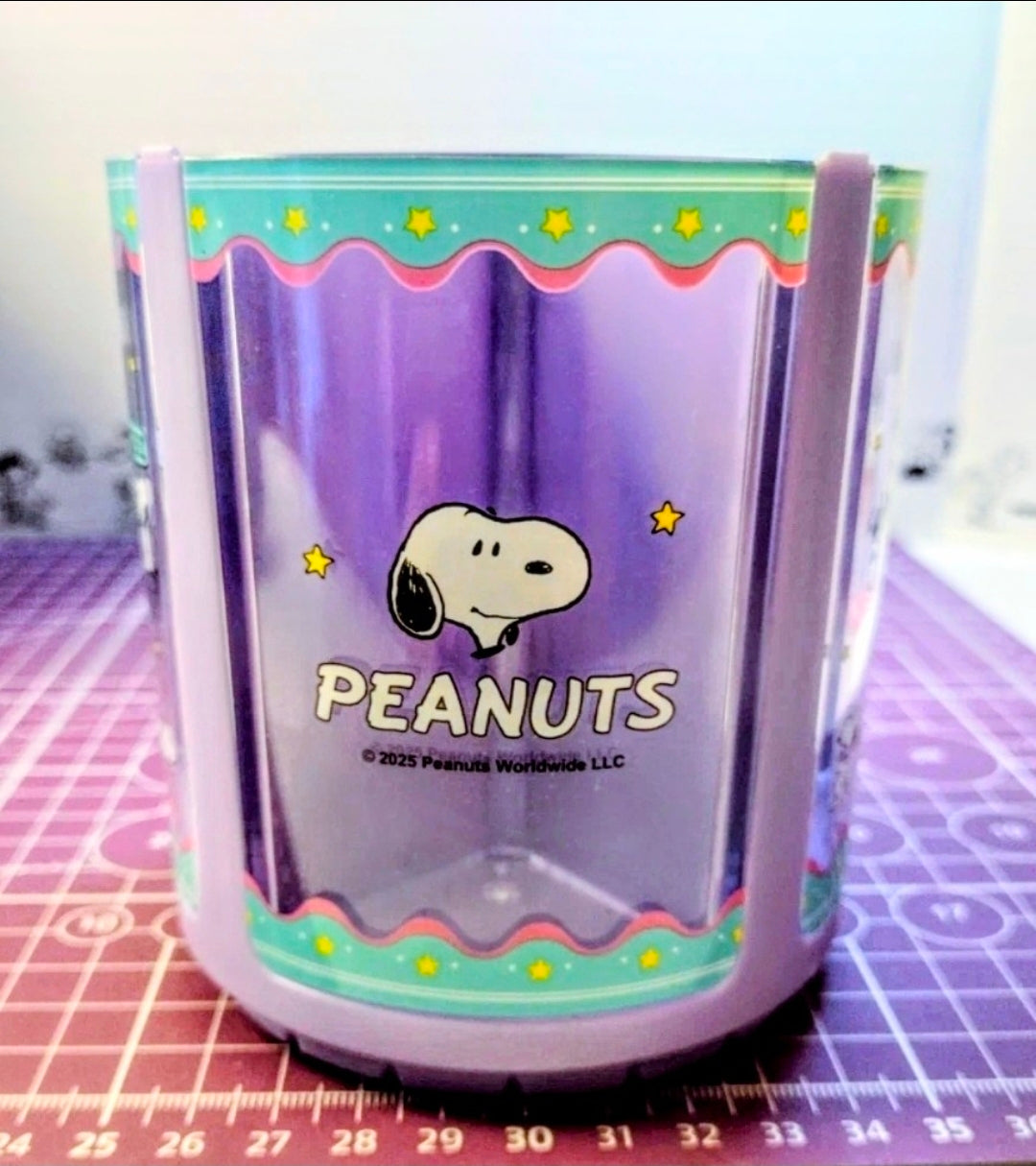 Purple acrylic Peanuts spinning pen holder with Snoopy illustration and star border