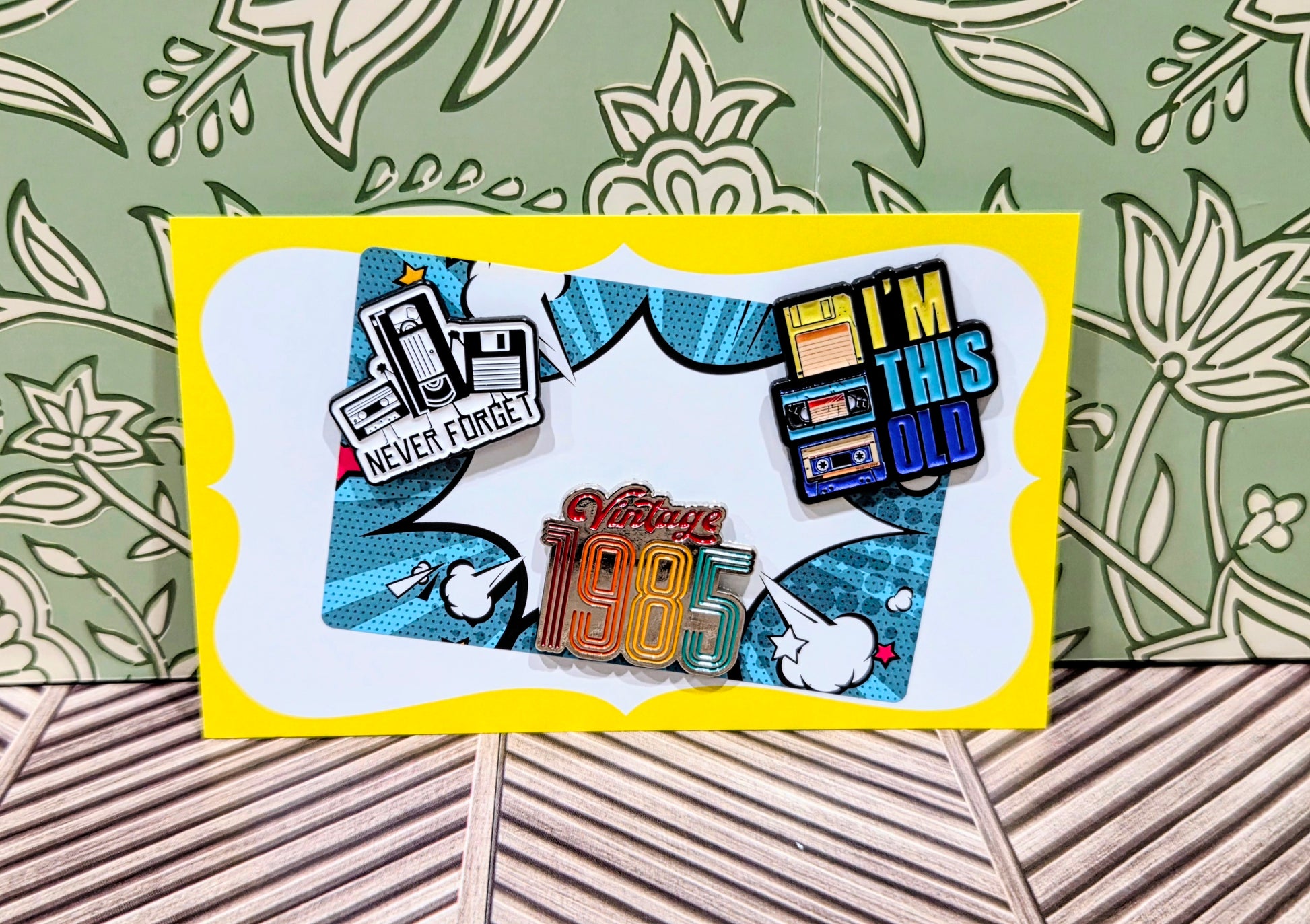 Enamel pin set card featuring 'I'm This Old', 'Never Forget', and 'Vintage 1985' pins