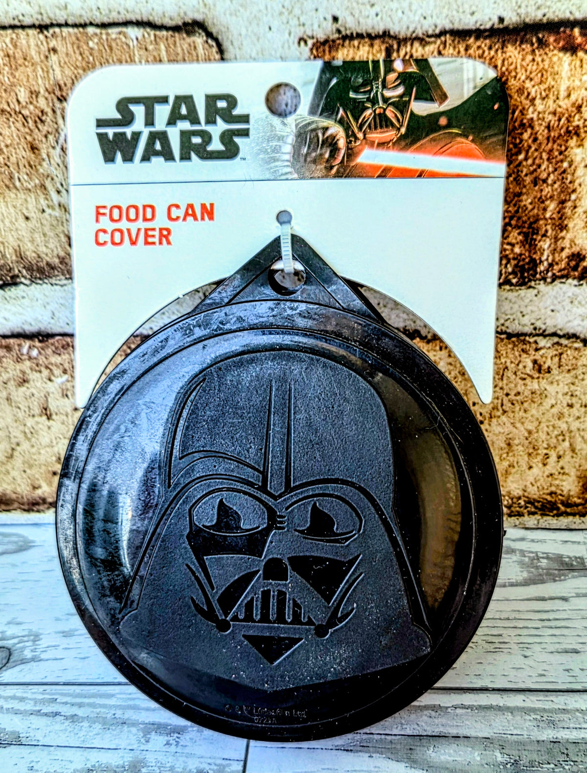 Star Wars food can cover with Darth Vader logo, black molded plastic.