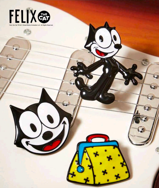 Enamel pin set with Felix cat face, body pose, and yellow bag design