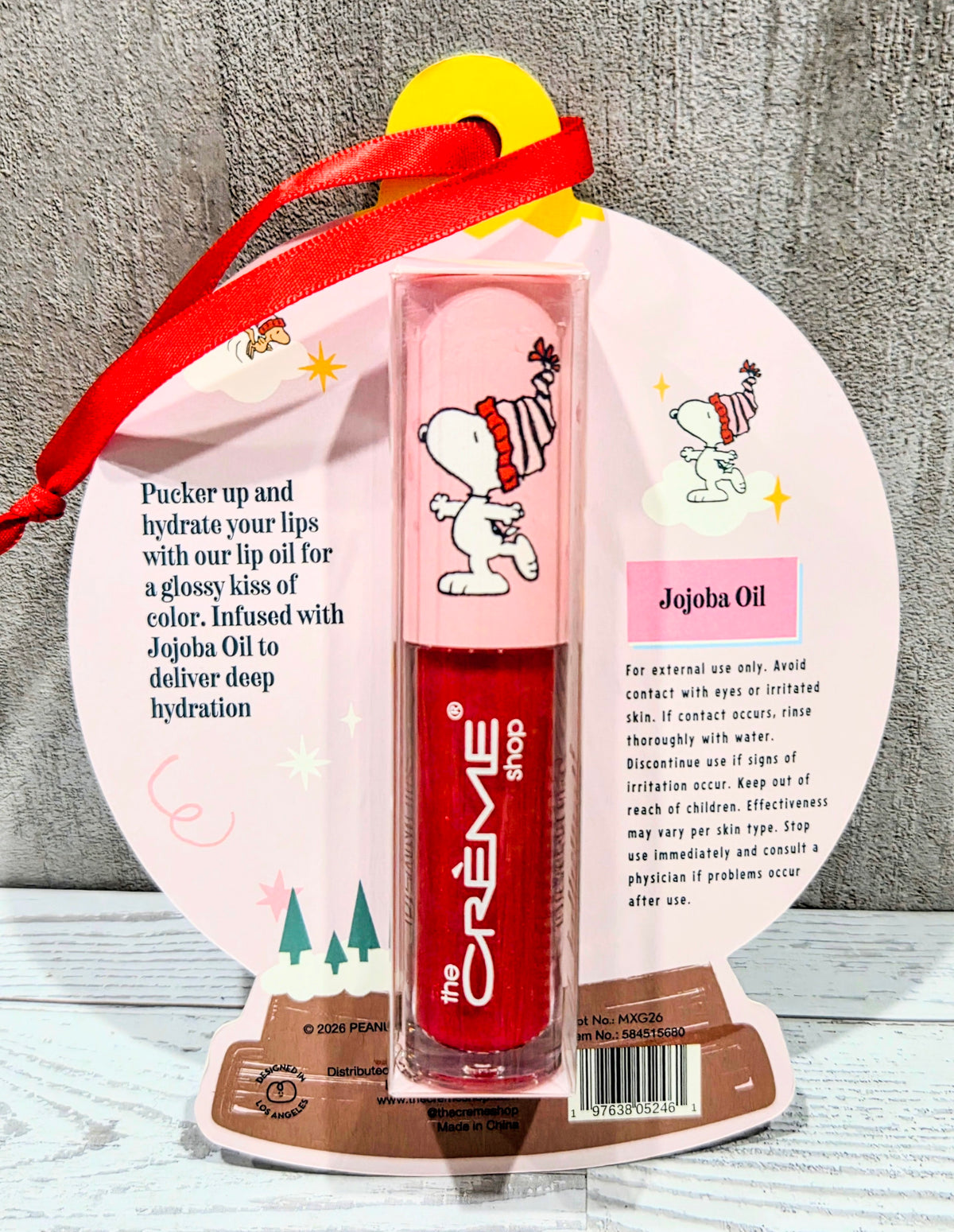 Tinted jelly lip oil set with red glitter tube and Frosted Berry Snoopy packaging