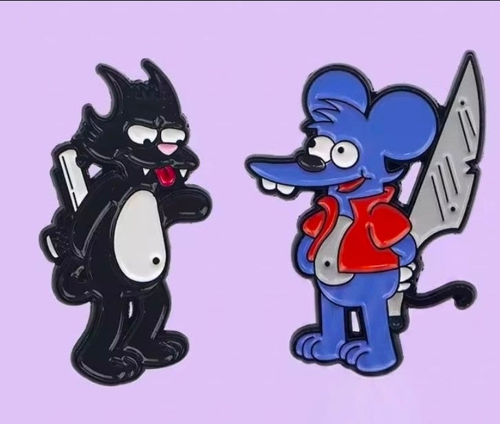 Two enamel pins: black cat and blue character holding a sword, side by side