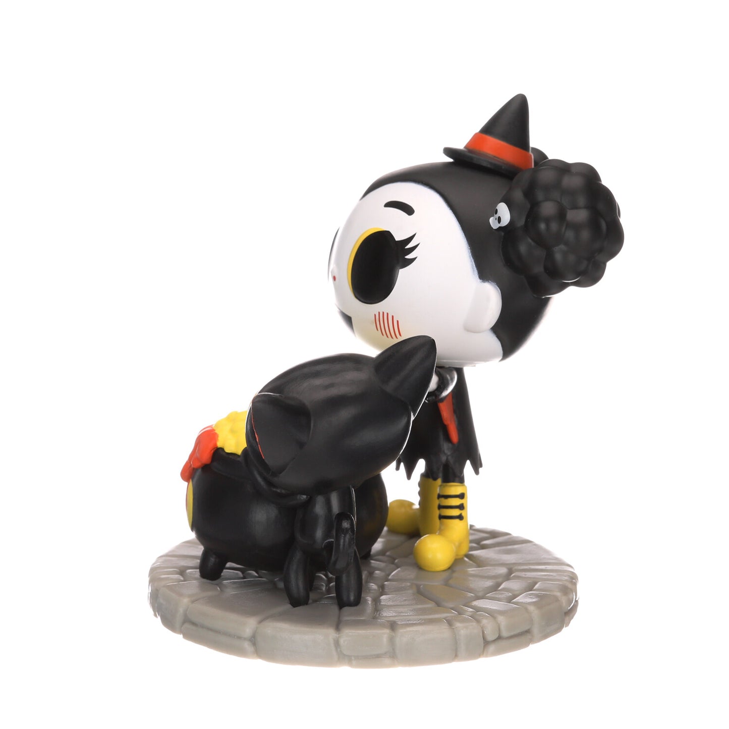 Black-and-white vinyl character figure with orange cone hat and black outfit, on base