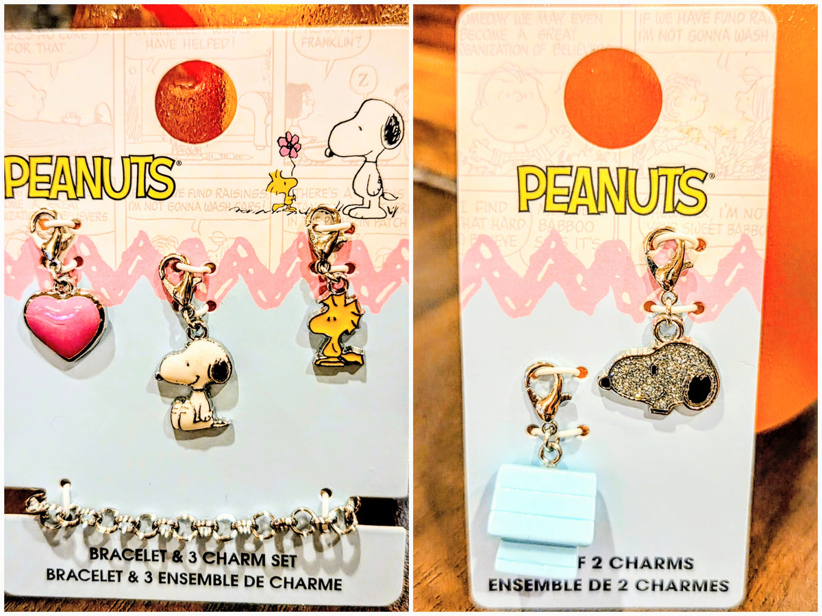 Two Peanuts charm sets on cards: bracelet with three charms and set with two charms