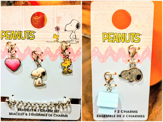 Two Peanuts charm sets on cards: bracelet with three charms and set with two charms