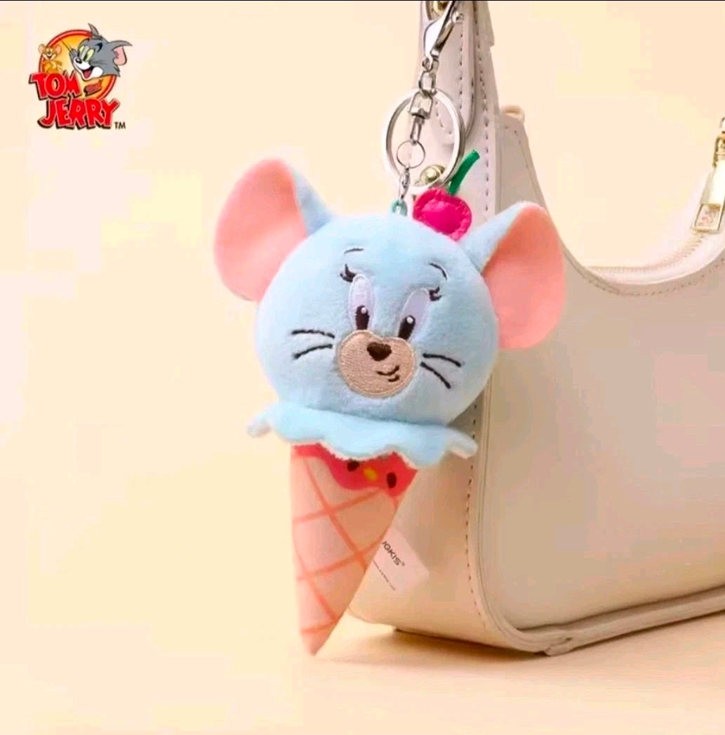 Light-blue plush ice cream cone keychain attached to a bag strap