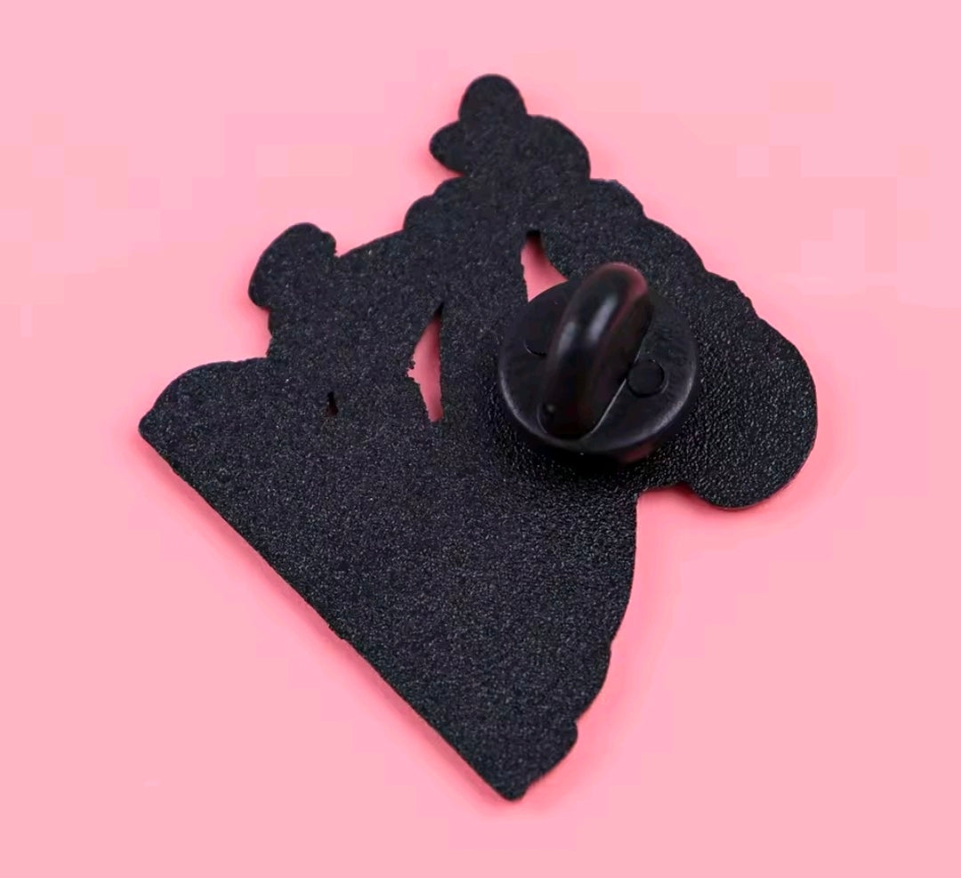 Back view of one black enamel pin with round clasp and posts.